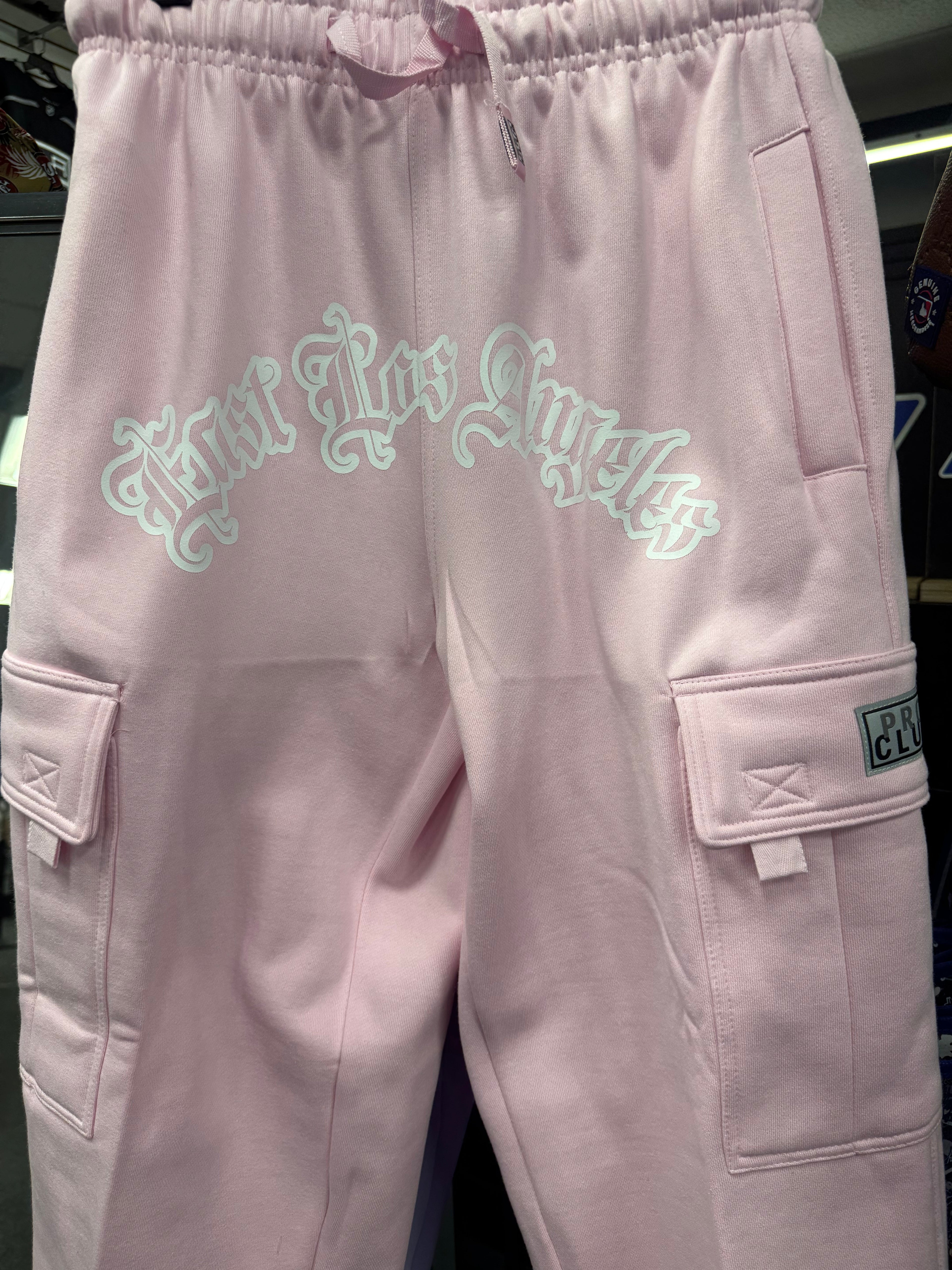 Pro Club Fleece Cargo Pants in pink featuring "East Los Angeles" graphic and cargo pockets for style and functionality.