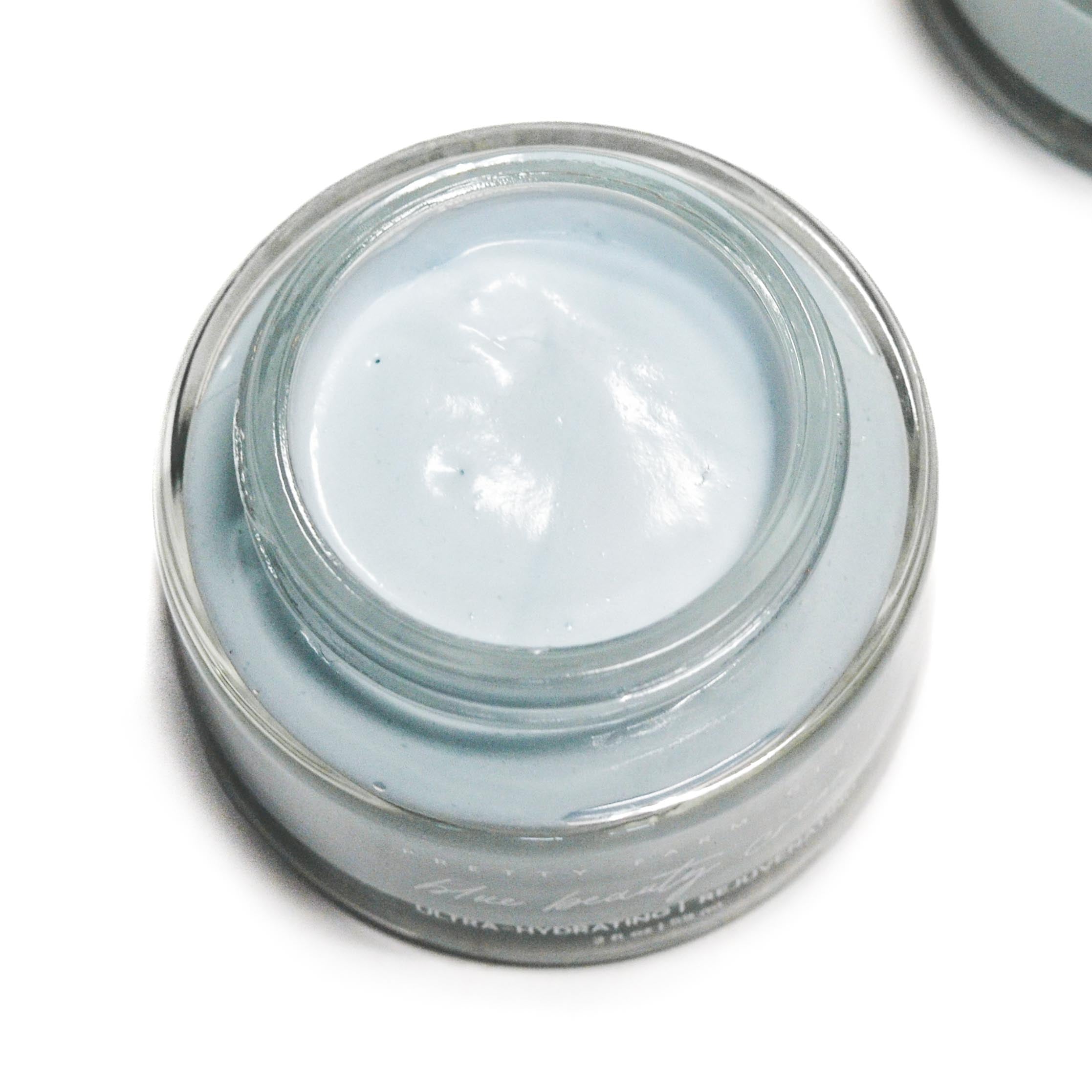 Blue Beauty Cream Soothing Tallow Face Cream in a clear jar, featuring a smooth, light blue cream inside.