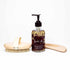 Body Care Lymphatic Routine Kit featuring a bottle of botanical body oil, a wooden dry brush, and a massage tool.