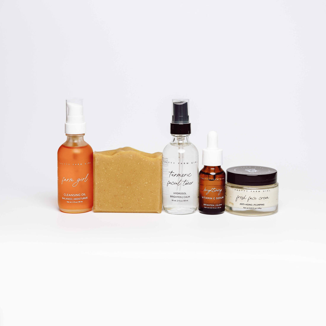 Dark Spot Brightening Kit featuring cleansing oil, turmeric peel, serum, soap, and face cream for skin brightening.