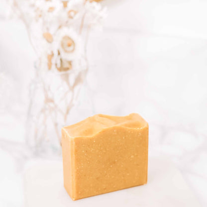 Dark Spot Brightening Kit includes a bar of brightening soap, featuring a smooth, golden texture.