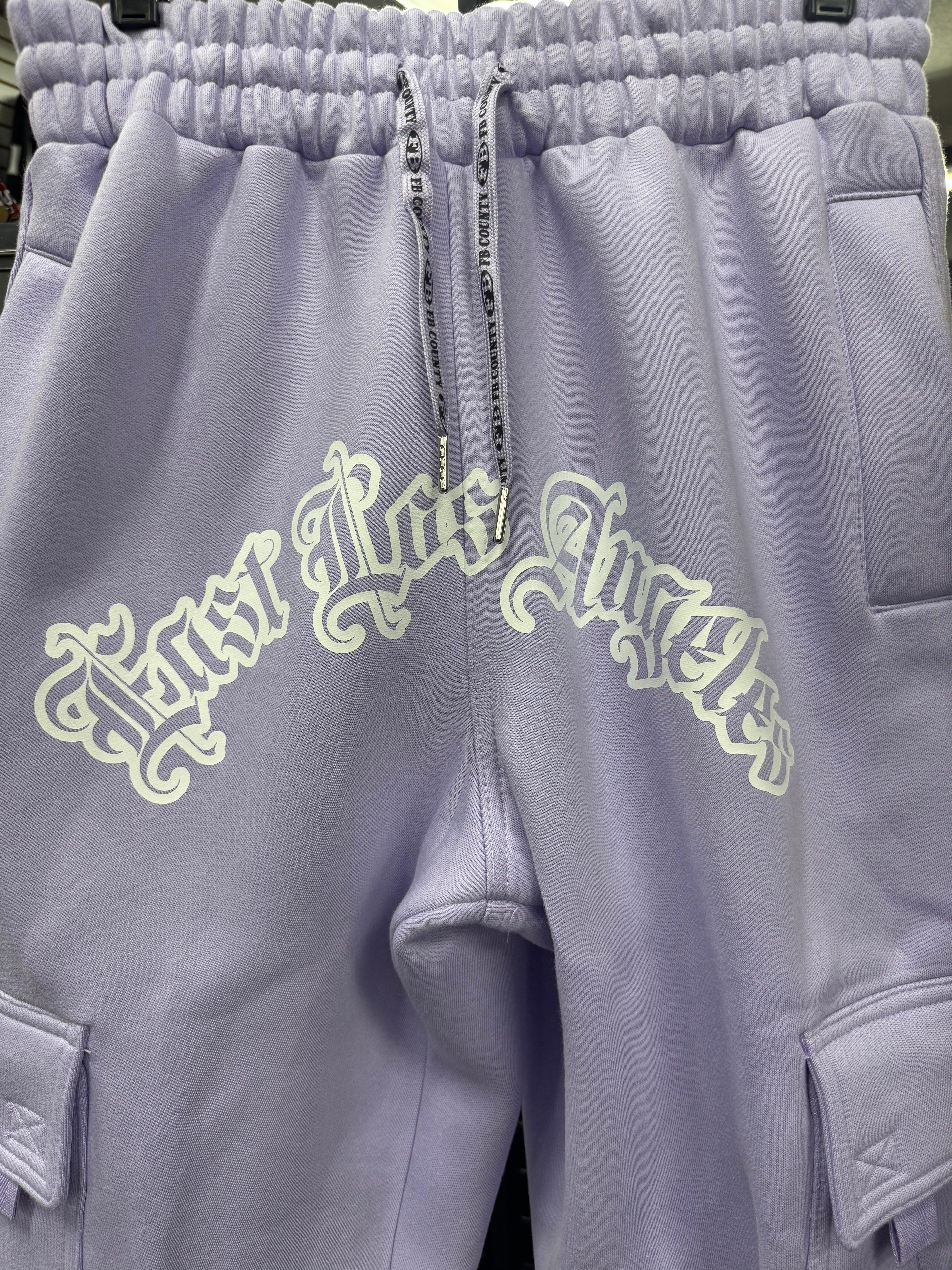 FB County Fleece Cargo Pants in lavender with "East Los Angeles" graphic in white on the front. Features cargo pockets.
