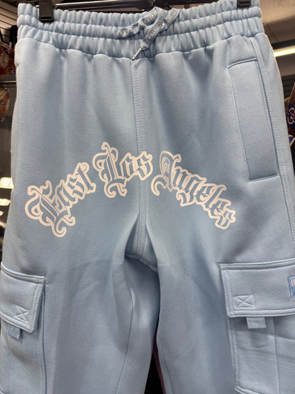 Light blue fleece cargo pants featuring "East Los Angeles" printed in white on the back. Includes side pockets.
