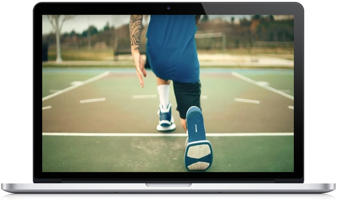 Jump 99 Training Shoes manual and videos displayed on a laptop, featuring a person running on a basketball court.