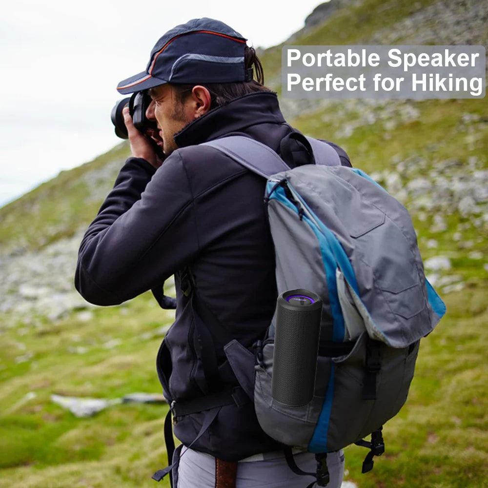 P3 Portable Bluetooth Speaker nestled in a backpack, ideal for hiking, with a person taking photos in nature.
