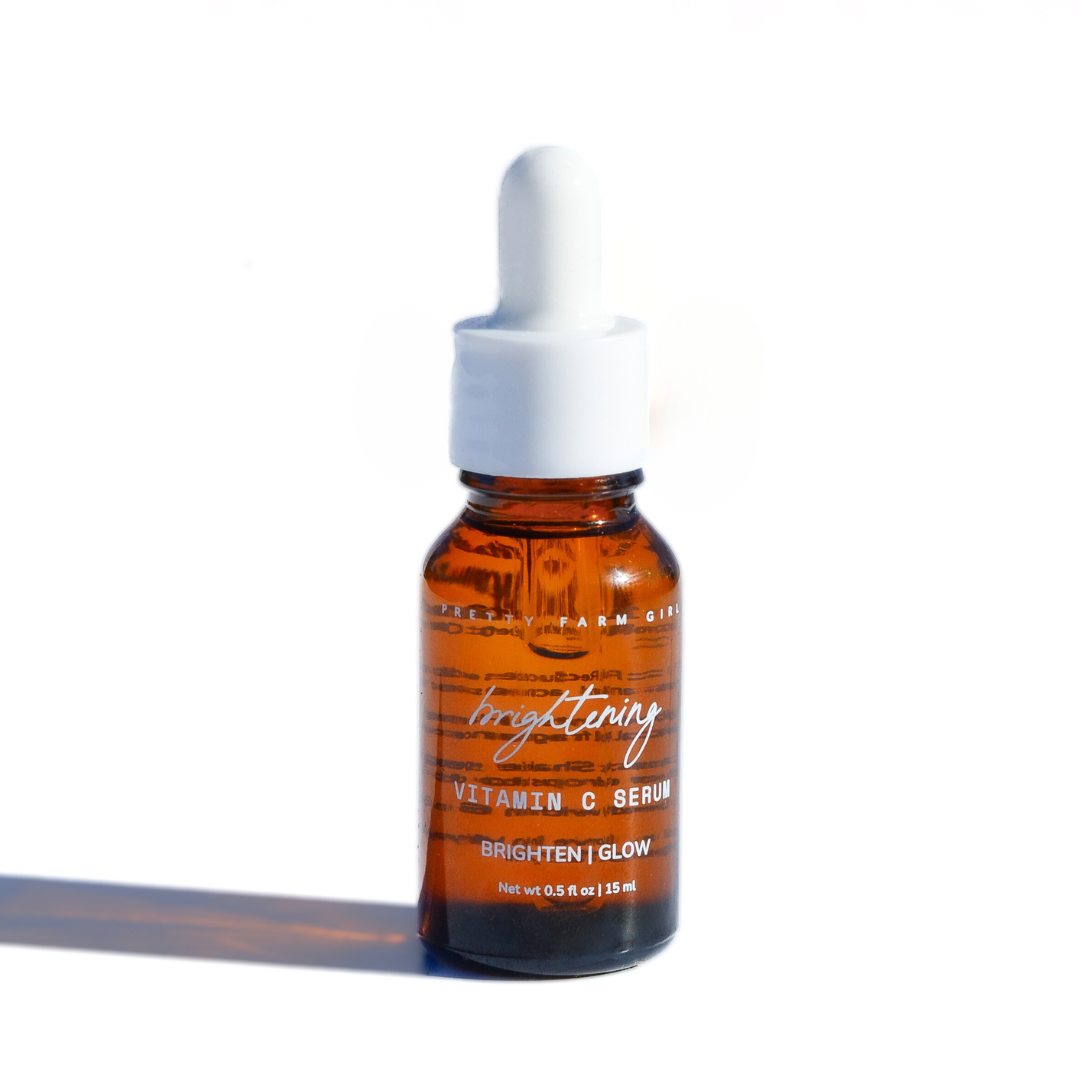 Dark Spot Brightening Kit featuring a small amber glass bottle of Vitamin C serum with a dropper cap.