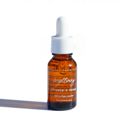 Dark Spot Brightening Kit featuring a small amber glass bottle of Vitamin C serum with a dropper cap.